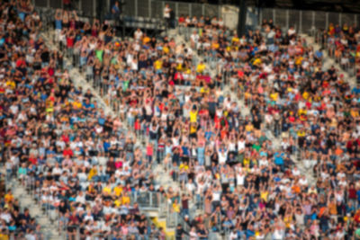 Defocused image of people sitting in stadium