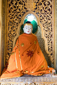 Statue of buddha against building