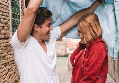 Midsection of couple standing outdoors