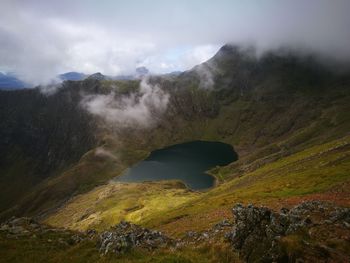 Scenic view of mountain against cloudy sky