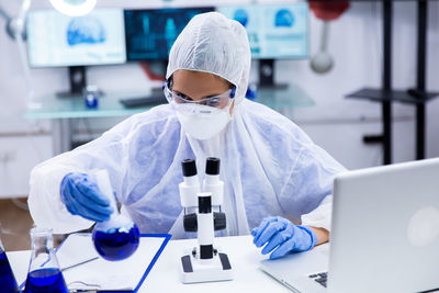 Portrait of woman using mobile phone in laboratory