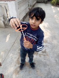 Portrait of boy holding camera