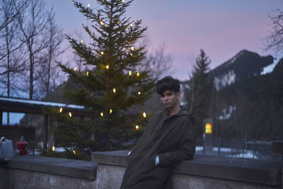 Man against christmas tree during sunset