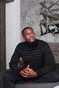 Portrait of mature man sitting at home