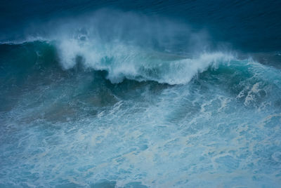 Waves breaking against sea