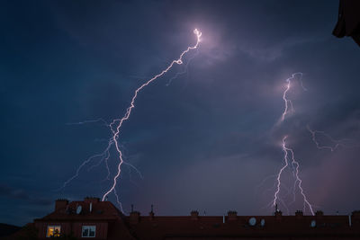 Low angle view of lightning against sky at night