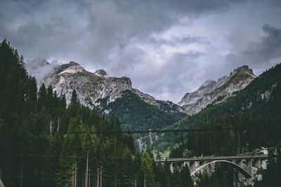 Panoramic view of bridge and mountains against sky