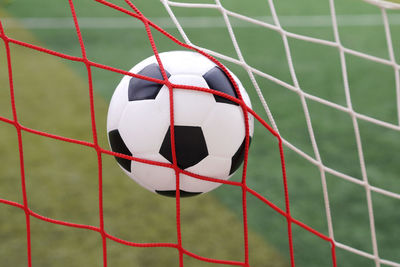 Close-up of soccer ball in goalpost