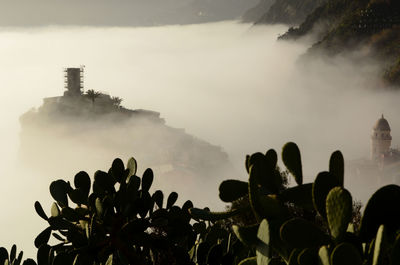 Low angle view of people on mountain against sky