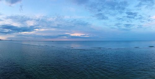 Scenic view of calm sea against cloudy sky