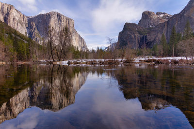 Mountain reflections, including half dome, in the merced river.