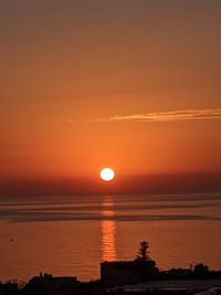 Scenic view of sea against romantic sky at sunset