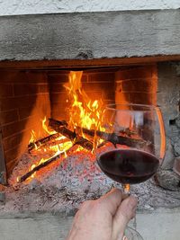 Hand holding burning candles