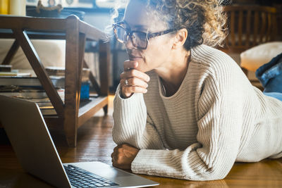 Young woman using laptop at table