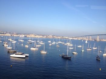 High angle view of boats moored in sea against clear sky