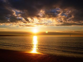 Scenic view of sea against romantic sky at sunset