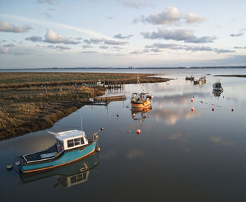 High angle view of boats moored in sea against sky