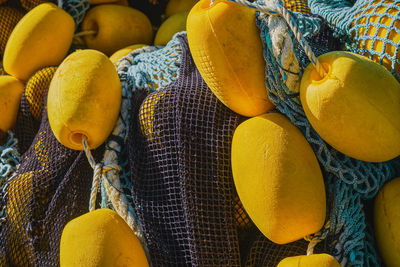 Background of colorful fishing nets with yellow floats, close-up, selective focus. 
