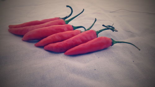 Close-up of red chili peppers on table