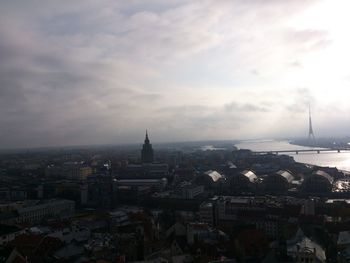 Cityscape against cloudy sky