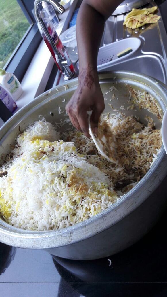 CLOSE-UP OF PERSON PREPARING FOOD IN TRAY