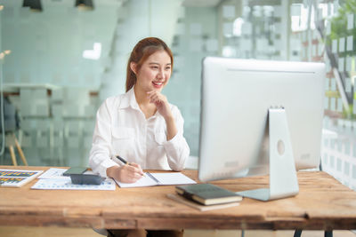 Businesswoman working at desk in office