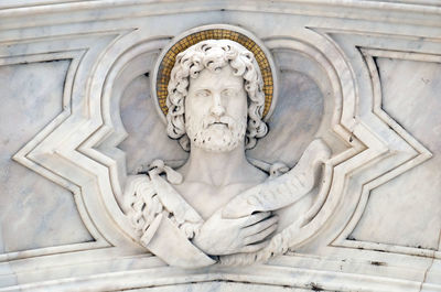 Saint john the baptist, relief on the facade of basilica of santa croce  in florence, italy