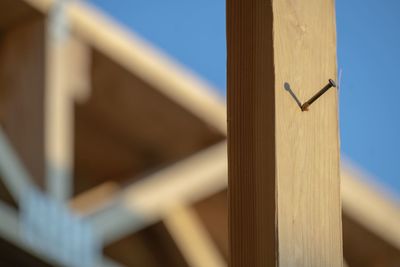 Low angle view of wooden fence against sky