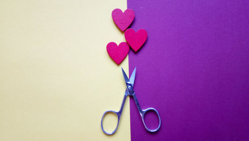 Close-up of heart shape over pink background