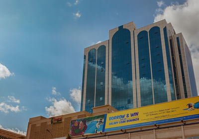 Low angle view of information sign against sky