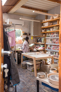 Woman with braided hair at her home art ceramics studio