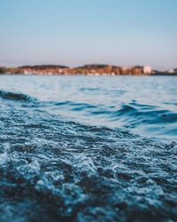 Surface level of sea against clear sky