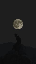 Low angle view of silhouette moon against clear sky at night