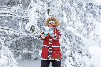 Portrait of woman standing on snow