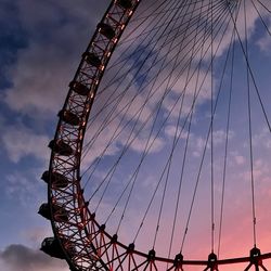 Low angle view of ferris wheel against sky