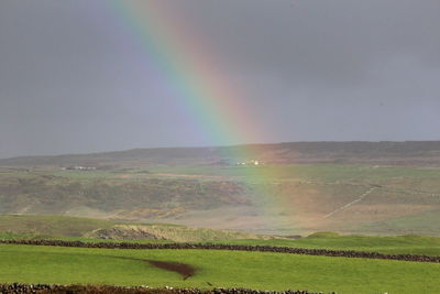 Scenic view of rainbow over field