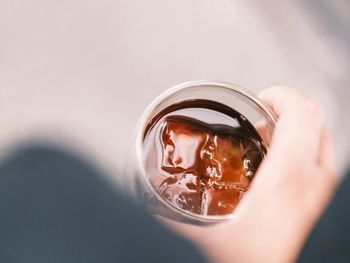 Cropped hand holding bottle