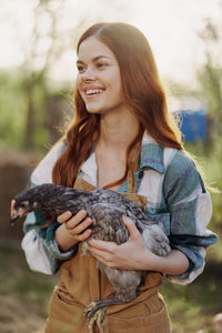 Portrait of smiling young woman looking away