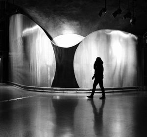 Full length of silhouette woman walking in subway