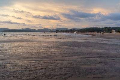 Scenic view of beach against sky during sunset