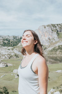 Portrait of young woman standing on mountain