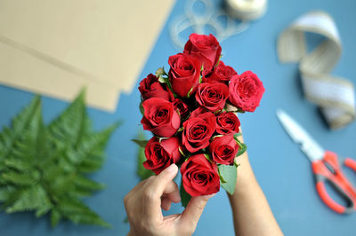 Low section of person holding rose bouquet