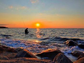 Scenic view of sea against sky during sunset