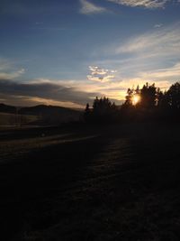 Scenic view of landscape against sky at sunset