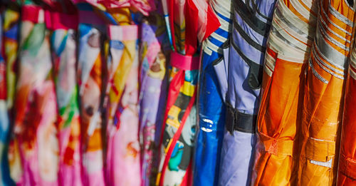 Multi colored umbrellas hanging at market stall