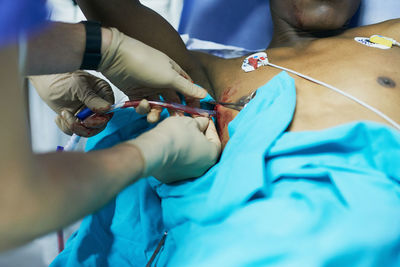 Midsection of doctor examining patient at clinic