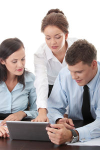 Young couple looking away while using smart phone