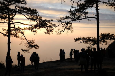 Silhouette people against sky during sunset