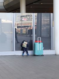 Full length of man standing by building