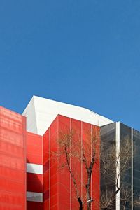 Low angle view of buildings against clear blue sky